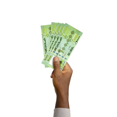 Black Hand holding 3D rendered 100000 Lebanese pound notes isolated on white background