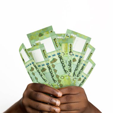 Black hands holding 3D rendered 100000 Lebanese pound notes. closeup of Hands holding Lebanese currency notes