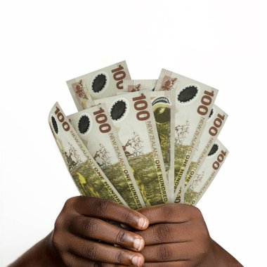 Black hands holding 3D rendered 100 New Zealand dollar notes. closeup of Hands holding New Zealand currency notes