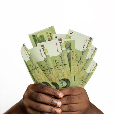 Black hands holding 3D rendered 100000 Iranian rial notes. closeup of Hands holding Iranian currency notes