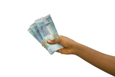 Fair hand holding 3D rendered Kuwaiti dinar notes isolated on white background