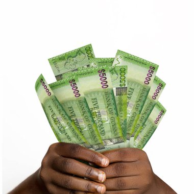 Black hands holding 3D rendered 5000 Guyanese dollar notes. closeup of Hands holding Guyanese currency notes