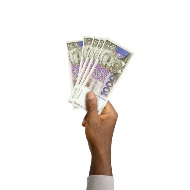 Black Hand holding 3D rendered Croatia 1000 Kuna notes isolated on white background