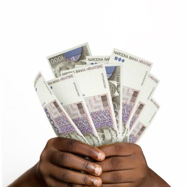 Black hands holding 3D rendered 1000 Croatian Kuna notes. closeup of Hands holding Croatian currency notes