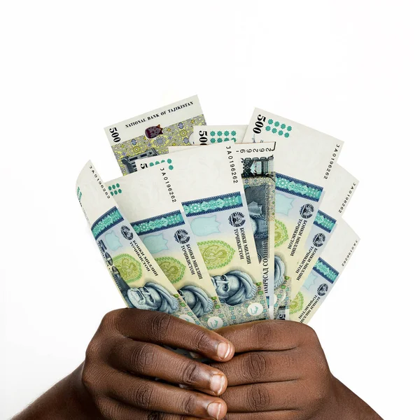 Black hands holding 3D rendered Tajikistani somoni notes. closeup of Hands holding Tajikistani currency notes