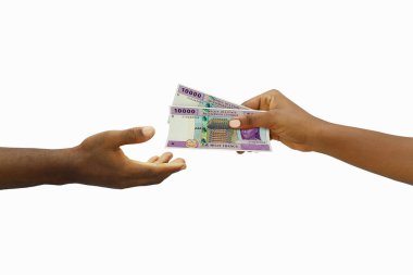 Hand giving 3D rendered Central African CFA franc notes to another hand. Hand receiving money