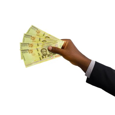 Black hand with suit holding 3D rendered 10000 Burundian franc notes isolated on white background