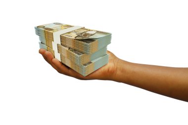 Hand Holding 3D rendered stack of Zambian Kwacha notes isolated on white background