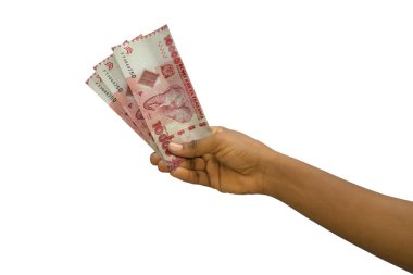 Fair hand holding 3D rendered Tanzanian shilling notes isolated on white background