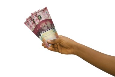 Fair hand holding 3D rendered 100 Scottish pound notes isolated on white background