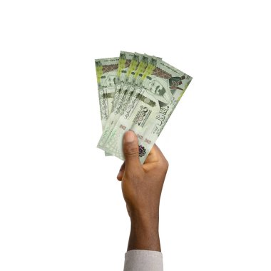 Black Hand holding 3D rendered Saudi Arabian Riyal notes isolated on white background