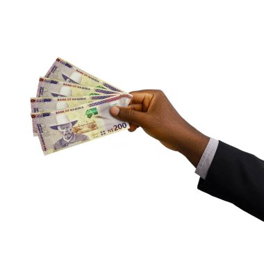 Black Hand with suit holding 3D rendered 200 Namibian dollar notes isolated on white background