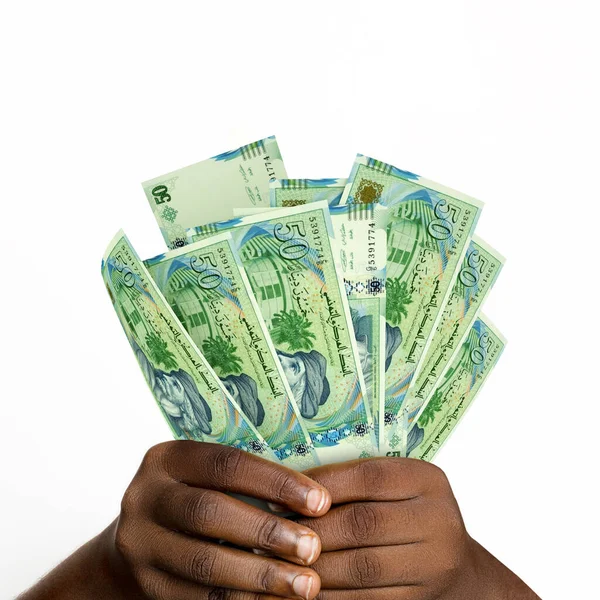 Black hands holding 3D rendered 50 Tunisian Dinar notes. closeup of Hands holding Tunisian currency notes