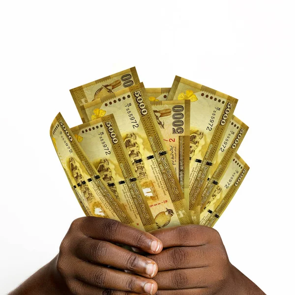 Black hands holding 3D rendered 5000 sri Lankan rupee notes. closeup of Hands holding sri Lankan currency notes