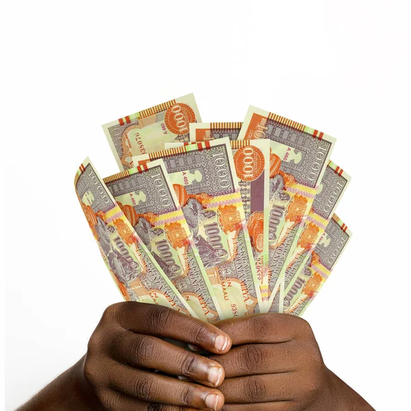 Black hands holding 3D rendered 1000 Somalian Shilling notes. closeup of Hands holding Somalian currency notes