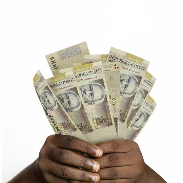 3D 'yi tutan eller 1000 tane Haiti kabağı kabağı oluşturdu. 1000 Haiti banknotunu tutan Eller 'e yakın çekim