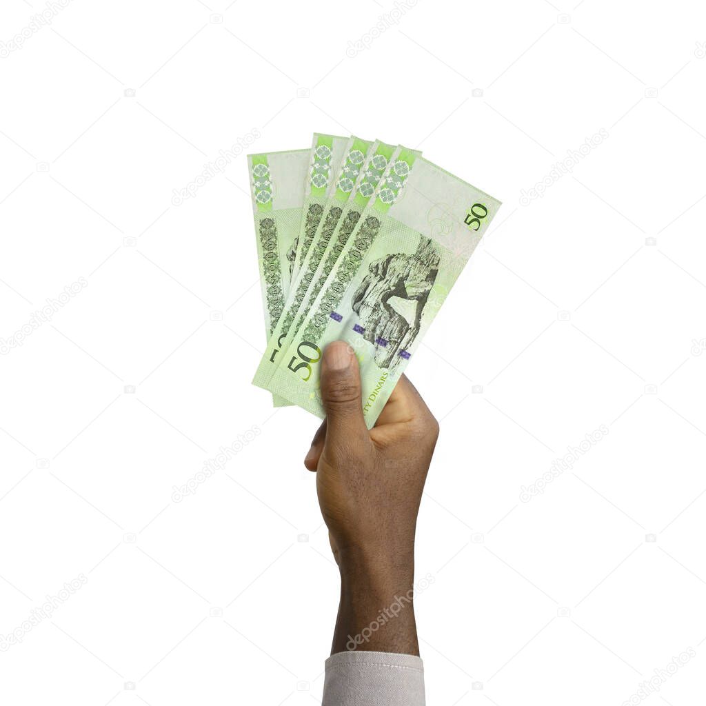 Black Hand holding 3D rendered 50 Libyan dinar notes isolated on white background