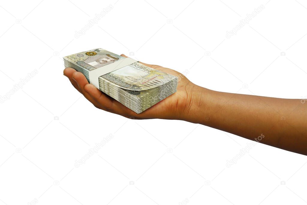 Hand Holding 3D rendered stack of Bahrain dinar notes isolated on white background