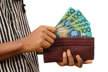 fair Female Hand Holding brown Purse With 100 Australian dollar notes, hand removing money out of purse isolated on white. removing money from wallet