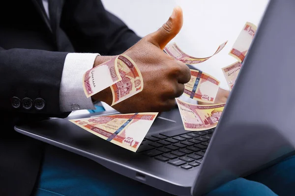 Afghan Afghanis notes coming out of laptop with Business man giving thumbs up, Financial concept. Make money on the Internet, working with a laptop