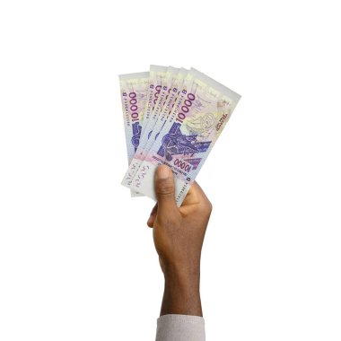 Black Hand holding 3D rendered 10000 West African CFA notes isolated on white background. Beninese, Burkinabe, Bissau-Guinean, Ivorian, Malian, Nigerien, Senegalese, Togolese