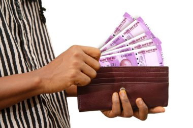 fair Female Hand Holding brown Purse With Indian rupee notes, hand removing money out of purse isolated on white. removing money from wallet