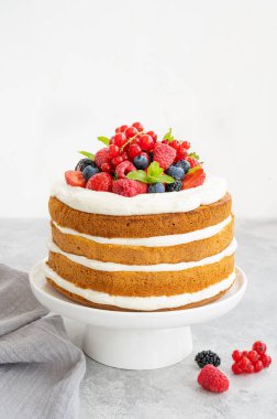 Ev yapımı, çırpılmış kremalı vanilyalı pasta ve gri beton arka planda taze böğürtlenler. Yaz pastası. Boşluğu kopyala