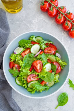 Taze sebzeli salata ve çimento kaplı bir kasede peynir. Yunan salatası, vejetaryen yemeği. Üst görünüm