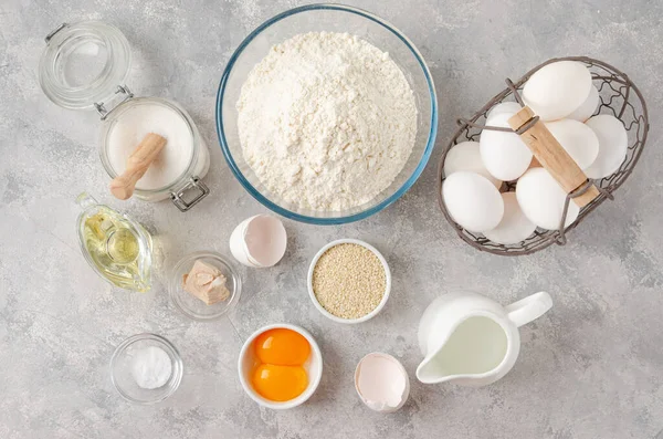 Ingredients for the preparation of challah bread dough, flour, water, sugar, eggs, yeast, oil, salt. Top view, copy space