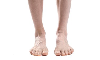 barefoot woman legs against white background, copy space 