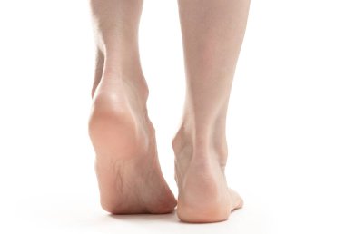 back view of barefoot woman legs against white background 