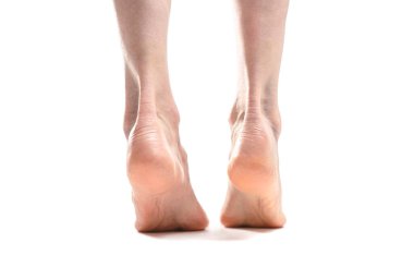 back view of barefoot woman legs against white background 