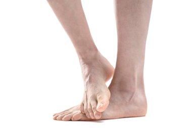 barefoot woman legs against white background, copy space 