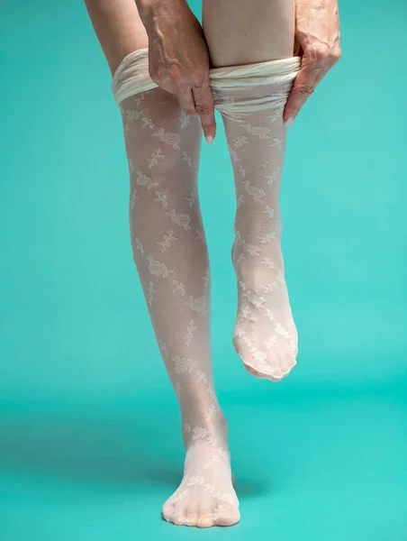 female legs, adult woman wearing white nylon stockings