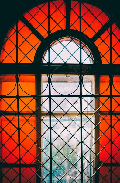 antique window with colored glass, stained glass, window in the old tower. High quality photo