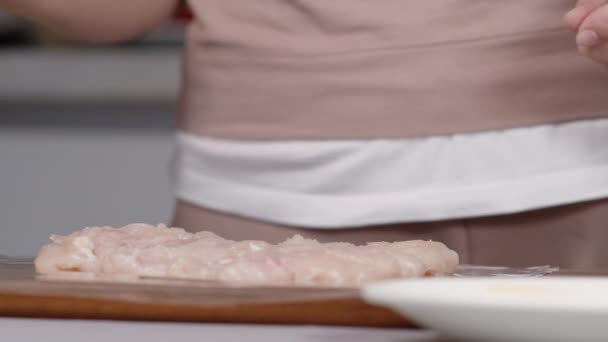 Kobieta gotować posypuje solą filet z kurczaka — Wideo stockowe