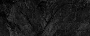 Fotokopi alanı olan koyu gri arkaplan. Taş desenli siyah grunge pankartı. Taş duvarın dokusu..