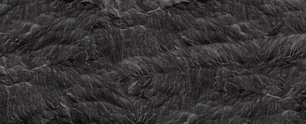 Abstract dark grey black slate background or texture. Close-up. Light gray rock backdrop.