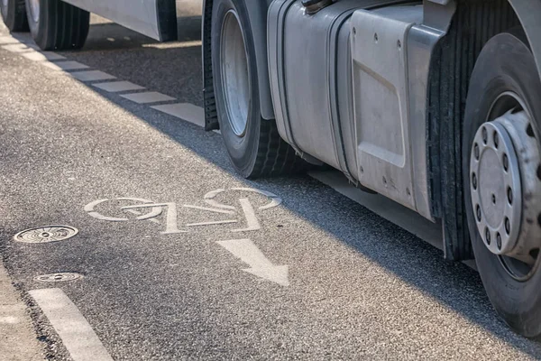 truck crossing the boundary line of a bike lane