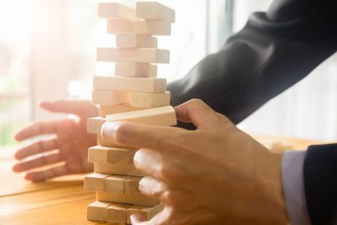 Business man gambling placing wooden block. Business concept  investment target and growth success process background present financial information planning, risk and marketing strategy analysis.