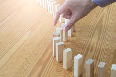 Business man gambling placing wooden block. Business concept  investment target and growth success process background present financial information planning, risk and marketing strategy analysis.