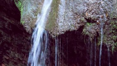beautiful loopable waterfall background closeup with relaxing water flow sound of nature in 4k