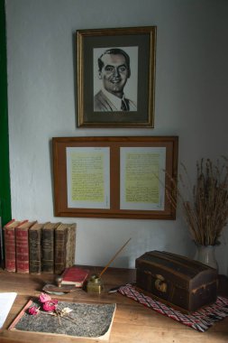 Federico Garcia Lorca's desk from his home in Valderrubio with the writer's photograph, books, inkwell, chest, dried roses