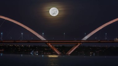 The moon sunset over the JK Bridge in Brasilia, Brazil. Supermoom.