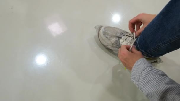 Wanita dalam sepatu transparan menutupi tali sepatu olahraga — Stok Video