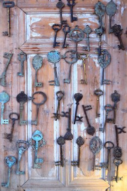 Oriental copper keys on the wooden background 