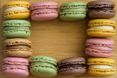 Macarons. Very colorful French typical cakes on wooden board. High quality photo