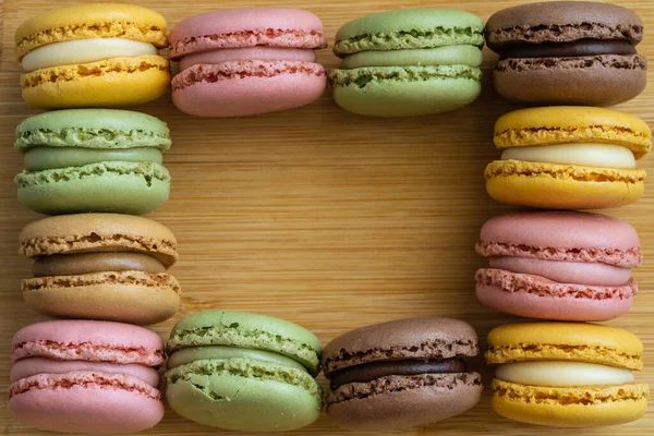 Macarons. Very colorful French typical cakes on wooden board. High quality photo