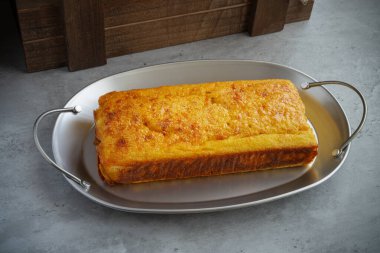 Delicious lemon sponge cake on a metal tray. High quality photo