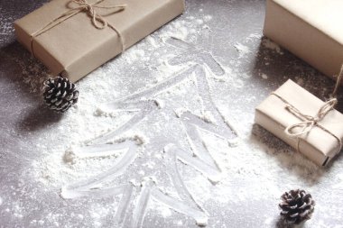 Hamurun üzerine bir Noel ağacı çiz ve geri dönüşümlü kağıttan yapılmış hediyeler.